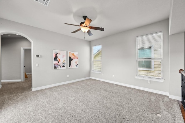 4024 Camacho St, Austin, TX 78723 - empty room with arched walkways, ceiling fan, and carpet