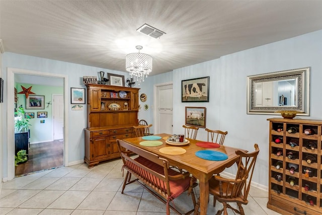 107 W Caddo St, Austin, TX 78753 - dining space featuring a chandelier and light tile patterned flooring