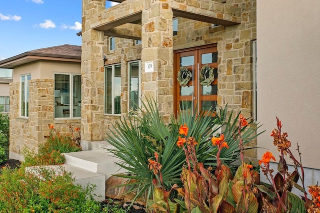 179 Sandy Creek Cv, Driftwood, TX 78619 - doorway to property with stone siding, stucco siding, and french doors