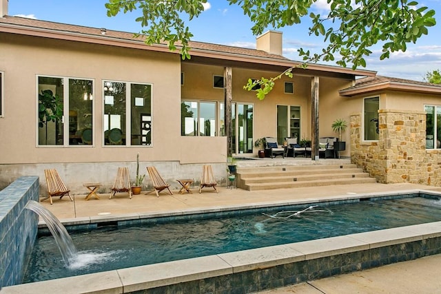 179 Sandy Creek Cv, Driftwood, TX 78619 - back of house featuring stucco siding, a chimney, an outdoor pool, a patio, and a wooden deck