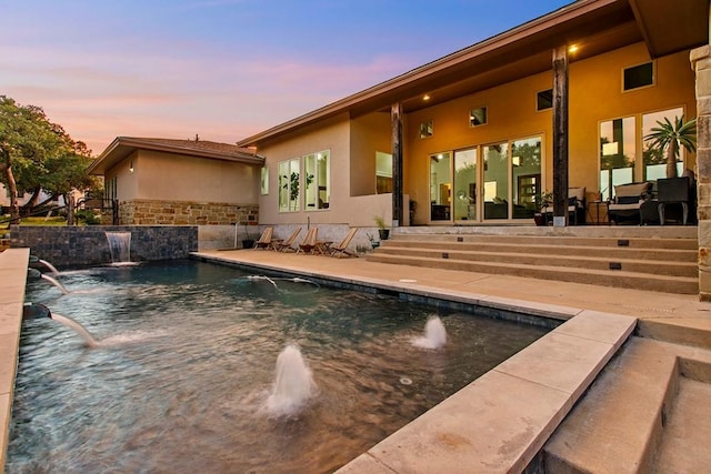179 Sandy Creek Cv, Driftwood, TX 78619 - pool at dusk featuring an outdoor pool and a patio area