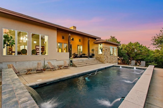 179 Sandy Creek Cv, Driftwood, TX 78619 - pool at dusk featuring a patio area and an outdoor pool