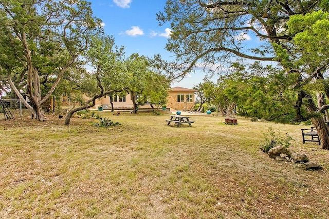 179 Sandy Creek Cv, Driftwood, TX 78619 - view of green lawn with an outdoor fire pit