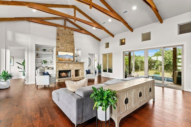 179 Sandy Creek Cv, Driftwood, TX 78619 - living area with high vaulted ceiling, a fireplace, beamed ceiling, dark wood-type flooring, and built in features