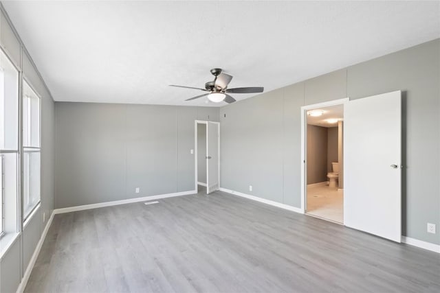 754 Altwein Ln, New Braunfels, TX 78130 - unfurnished bedroom with wood finished floors, a ceiling fan, and ensuite bath
