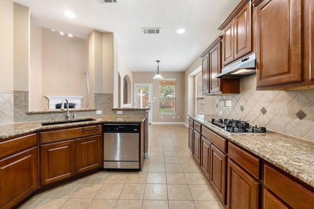 829 Zappa Dr, Cedar Park, TX 78613 - kitchen featuring stainless steel dishwasher, gas stovetop, under cabinet range hood, backsplash, and light tile patterned flooring