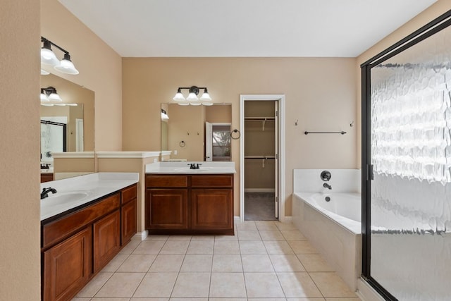 829 Zappa Dr, Cedar Park, TX 78613 - full bath featuring tile patterned flooring, a stall shower, a bath, two vanities, and a spacious closet