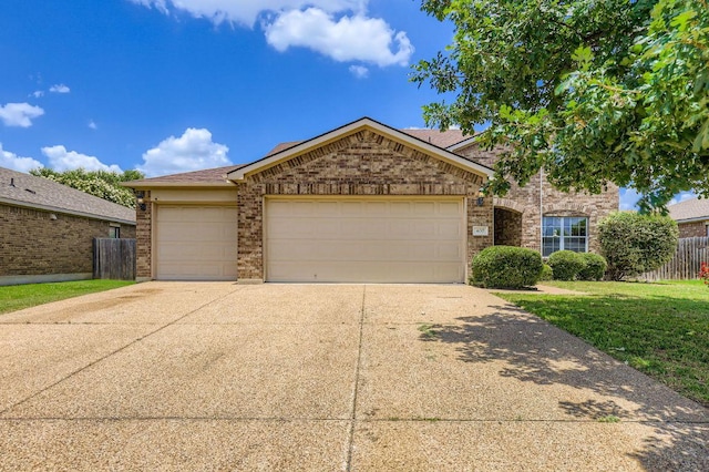400 Hummingbird Ln, Leander, TX 78641 - view of front of home featuring an attached garage, concrete driveway, and brick siding