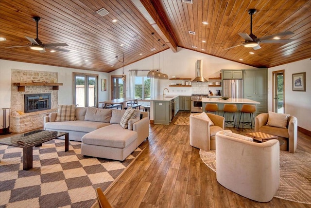 19811 W Ranch Road 152nd Rd, Llano, TX 78643 - living room featuring ceiling fan, wooden ceiling, hardwood / wood-style flooring, a stone fireplace, and recessed lighting