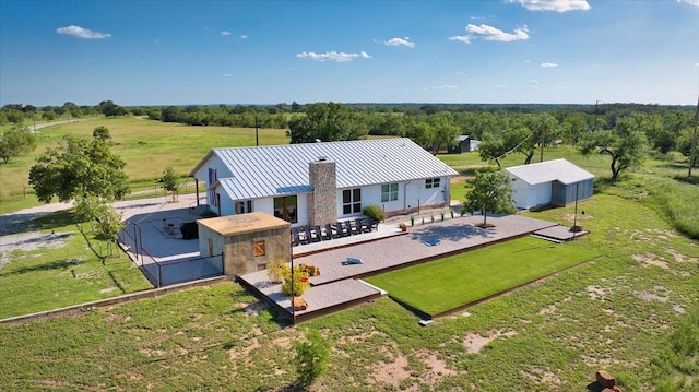 19811 W Ranch Road 152nd Rd, Llano, TX 78643 - rear view of property with a patio area, a chimney, stucco siding, a view of rural / pastoral area, and a metal roof
