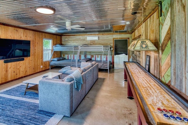 19811 W Ranch Road 152nd Rd, Llano, TX 78643 - living area featuring wood walls, a ceiling fan, and concrete floors