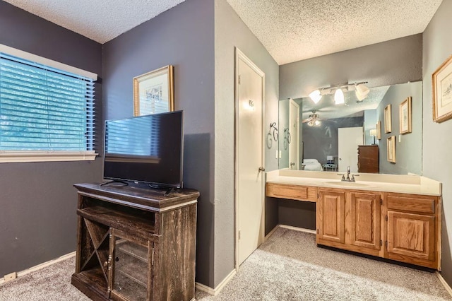 4513 Sidereal Dr, Austin, TX 78727 - bathroom with a textured ceiling, vanity, and ceiling fan