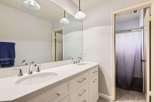4513 Sidereal Dr, Austin, TX 78727 - full bath with double vanity, a shower with shower curtain, and a textured ceiling