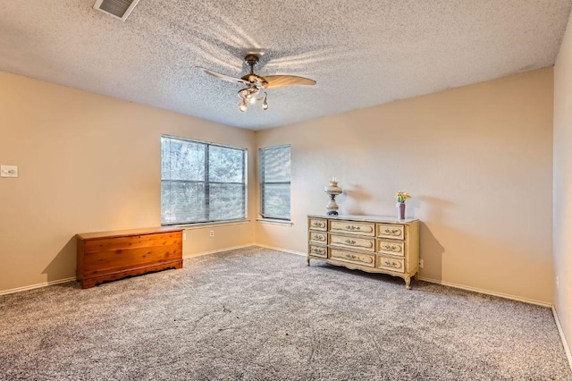 4513 Sidereal Dr, Austin, TX 78727 - carpeted bedroom with a textured ceiling and a ceiling fan