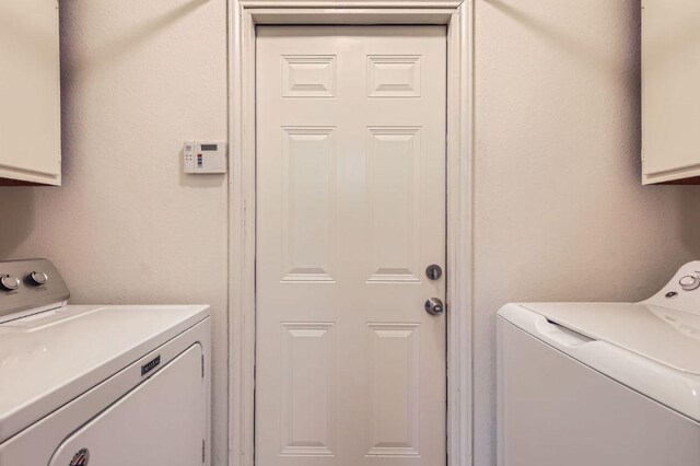 4513 Sidereal Dr, Austin, TX 78727 - washroom with cabinet space and washer and dryer