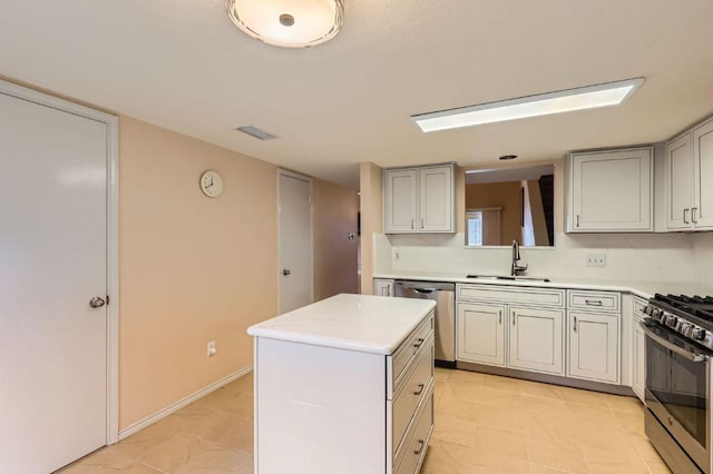 4513 Sidereal Dr, Austin, TX 78727 - kitchen with appliances with stainless steel finishes, a kitchen island, light countertops, and light tile patterned floors