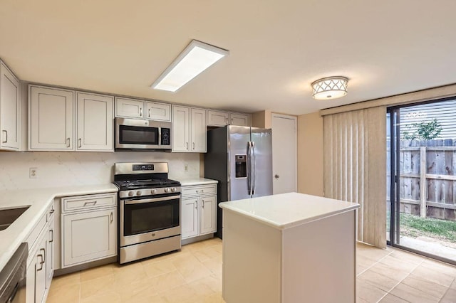 4513 Sidereal Dr, Austin, TX 78727 - kitchen with stainless steel appliances, light countertops, a kitchen island, and light tile patterned flooring