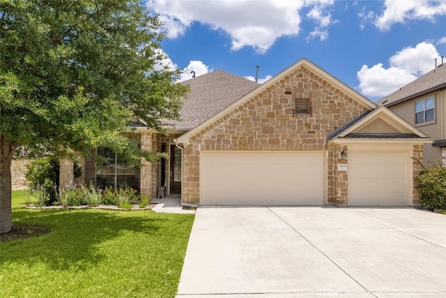 3204 Herrero Path, Cedar Park, TX 78641 - view of front of home featuring stone siding, an attached garage, concrete driveway, and a front lawn
