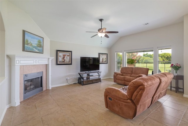 3204 Herrero Path, Cedar Park, TX 78641 - living area featuring vaulted ceiling, a ceiling fan, a tiled fireplace, and light tile patterned flooring