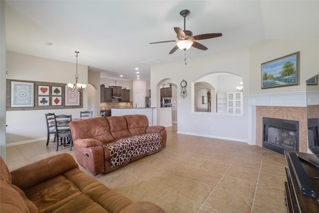 3204 Herrero Path, Cedar Park, TX 78641 - living area featuring a chandelier, ceiling fan, light tile patterned floors, a fireplace, and arched walkways
