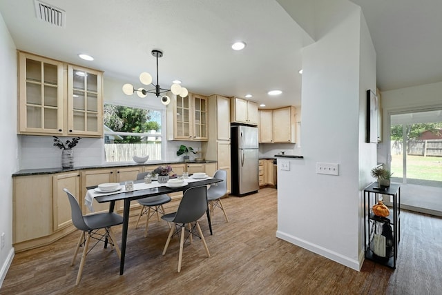 9224 Partridge Cir, Austin, TX 78758 - dining area with healthy amount of natural light, a chandelier, light wood-type flooring, and recessed lighting