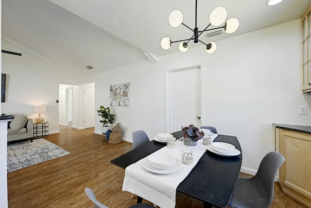 9224 Partridge Cir, Austin, TX 78758 - dining room with a chandelier, lofted ceiling, and wood finished floors