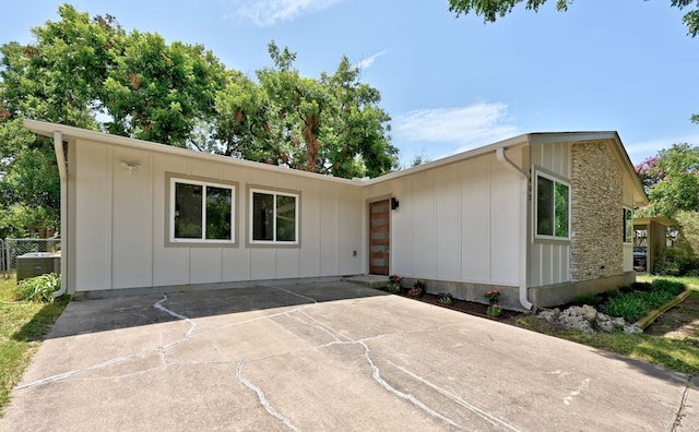 4803 Broadhill Dr, Austin, TX 78723 - view of front of house with board and batten siding, a patio, and concrete driveway