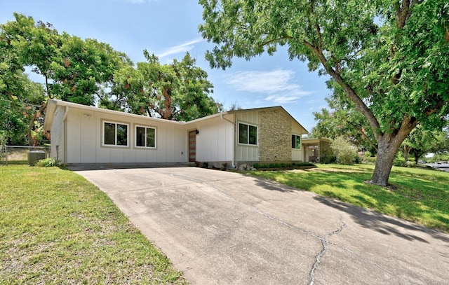 4803 Broadhill Dr, Austin, TX 78723 - ranch-style house featuring board and batten siding and driveway