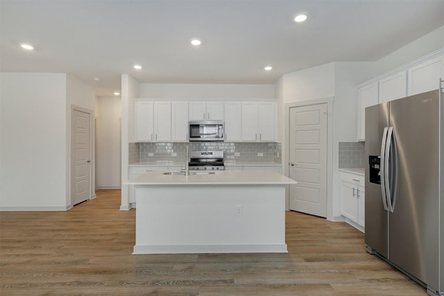 13804 Bavarian Forest Dr, Pflugerville, TX 78660 - kitchen featuring appliances with stainless steel finishes, light countertops, white cabinetry, and recessed lighting