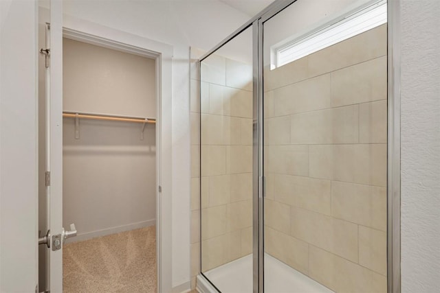 13804 Bavarian Forest Dr, Pflugerville, TX 78660 - bathroom featuring a stall shower and a walk in closet