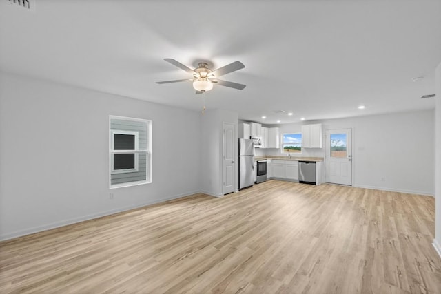 524 Aplite Pass, Maxwell, TX 78656 - unfurnished living room featuring light wood-type flooring, recessed lighting, and ceiling fan