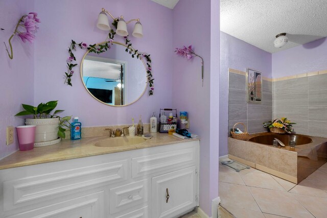 1121 Nola Ruth Blvd, Harker Heights, TX 76548 - full bath with vanity, a garden tub, tile patterned floors, a textured ceiling, and ceiling fan