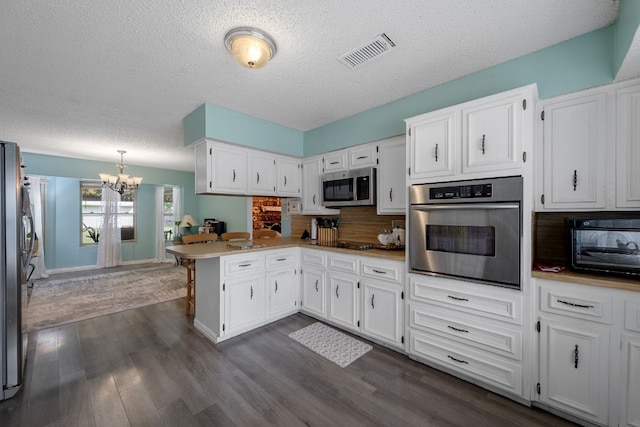 1121 Nola Ruth Blvd, Harker Heights, TX 76548 - kitchen with black appliances, a chandelier, white cabinets, a peninsula, and a textured ceiling