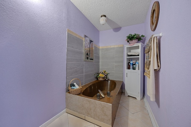 1121 Nola Ruth Blvd, Harker Heights, TX 76548 - bathroom featuring tile patterned flooring, a bath, a textured ceiling, and a textured wall
