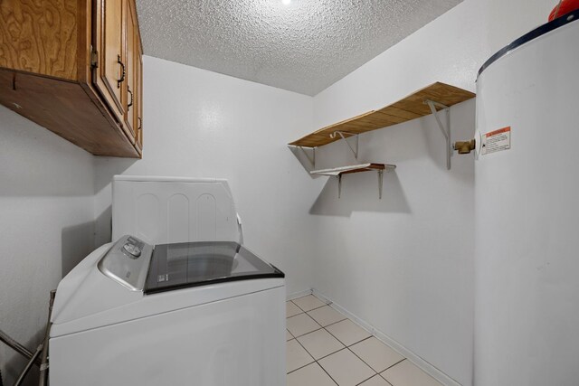 1121 Nola Ruth Blvd, Harker Heights, TX 76548 - laundry room with washer / dryer, cabinet space, electric water heater, a textured ceiling, and light tile patterned floors
