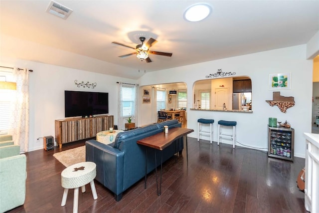 13920 Marathon Rd, Austin, TX 78717 - living area with a ceiling fan, dark wood-style flooring, wine cooler, and arched walkways