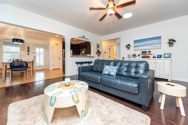 13920 Marathon Rd, Austin, TX 78717 - living area featuring a ceiling fan, dark wood-style flooring, and arched walkways