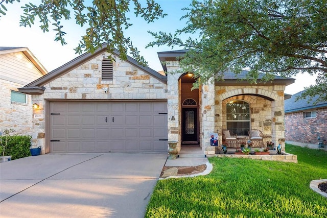 13920 Marathon Rd, Austin, TX 78717 - view of front of property featuring stone siding, an attached garage, driveway, and a front lawn