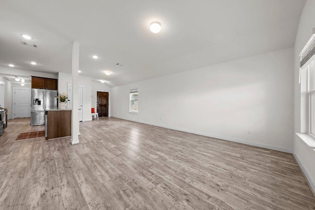 136 Gidran Trl, Georgetown, TX 78626 - unfurnished living room featuring light wood-type flooring, recessed lighting, and vaulted ceiling