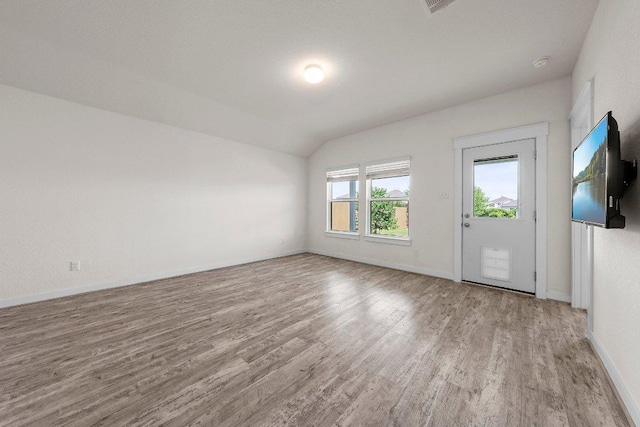 136 Gidran Trl, Georgetown, TX 78626 - empty room with wood finished floors and lofted ceiling