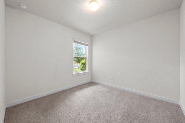 136 Gidran Trl, Georgetown, TX 78626 - unfurnished room featuring light colored carpet, a smoke detector, and a textured ceiling
