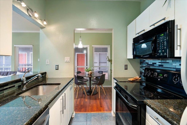 2804 Rio Grande St Unit 211, Austin, TX 78705 - kitchen featuring black appliances, crown molding, white cabinetry, dark stone counters, and backsplash