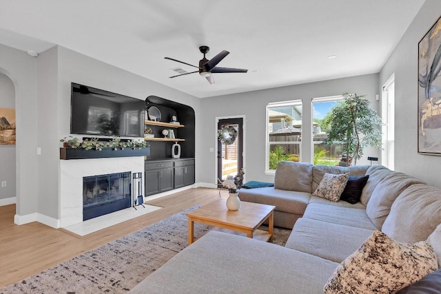 800 Sand Hill Branch Dr Unit 38, Austin, TX 78748 - living area with ceiling fan, wood finished floors, a fireplace, and arched walkways