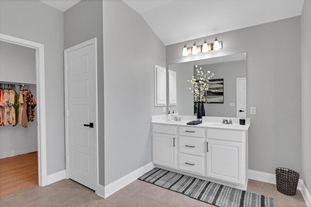 800 Sand Hill Branch Dr Unit 38, Austin, TX 78748 - full bathroom featuring double vanity, tile patterned flooring, lofted ceiling, and a spacious closet