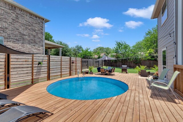 800 Sand Hill Branch Dr Unit 38, Austin, TX 78748 - view of swimming pool featuring a wooden deck, a fenced backyard, and outdoor dining space