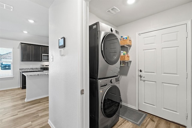 1037 Oxford Ln, Troy, TX 76579 - washroom featuring estacked washer and dryer, light wood-style flooring, and recessed lighting