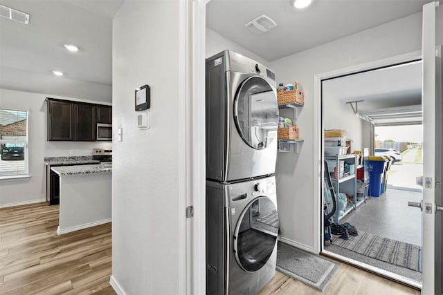 1037 Oxford Ln, Troy, TX 76579 - washroom featuring stacked washer / drying machine, light wood-type flooring, and recessed lighting