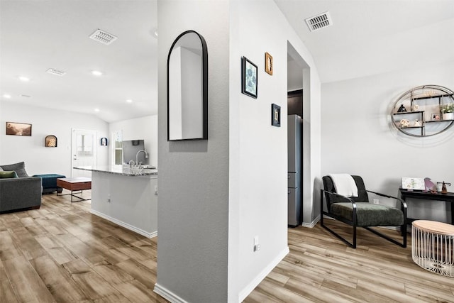 1037 Oxford Ln, Troy, TX 76579 - hallway with light wood finished floors, recessed lighting, and lofted ceiling