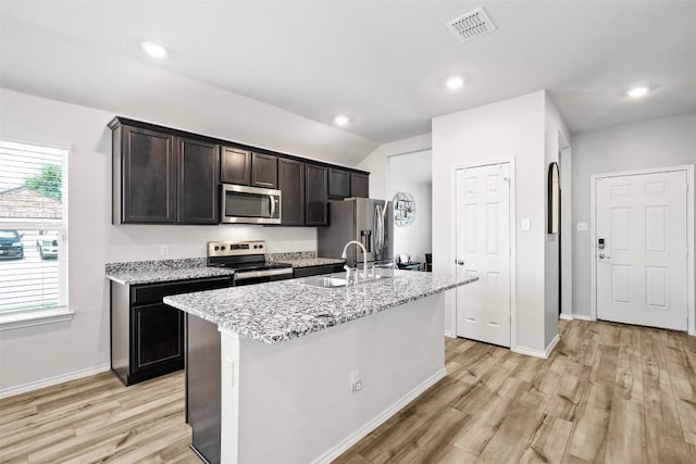 1037 Oxford Ln, Troy, TX 76579 - kitchen featuring appliances with stainless steel finishes, light wood-type flooring, an island with sink, light stone counters, and recessed lighting