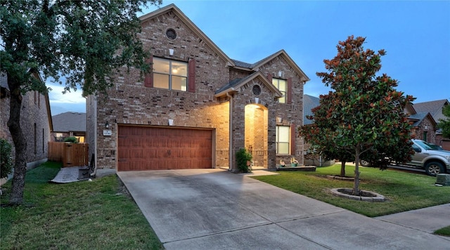 1236 Yellow Iris Rd, Leander, TX 78641 - traditional-style house featuring a garage, driveway, and brick siding